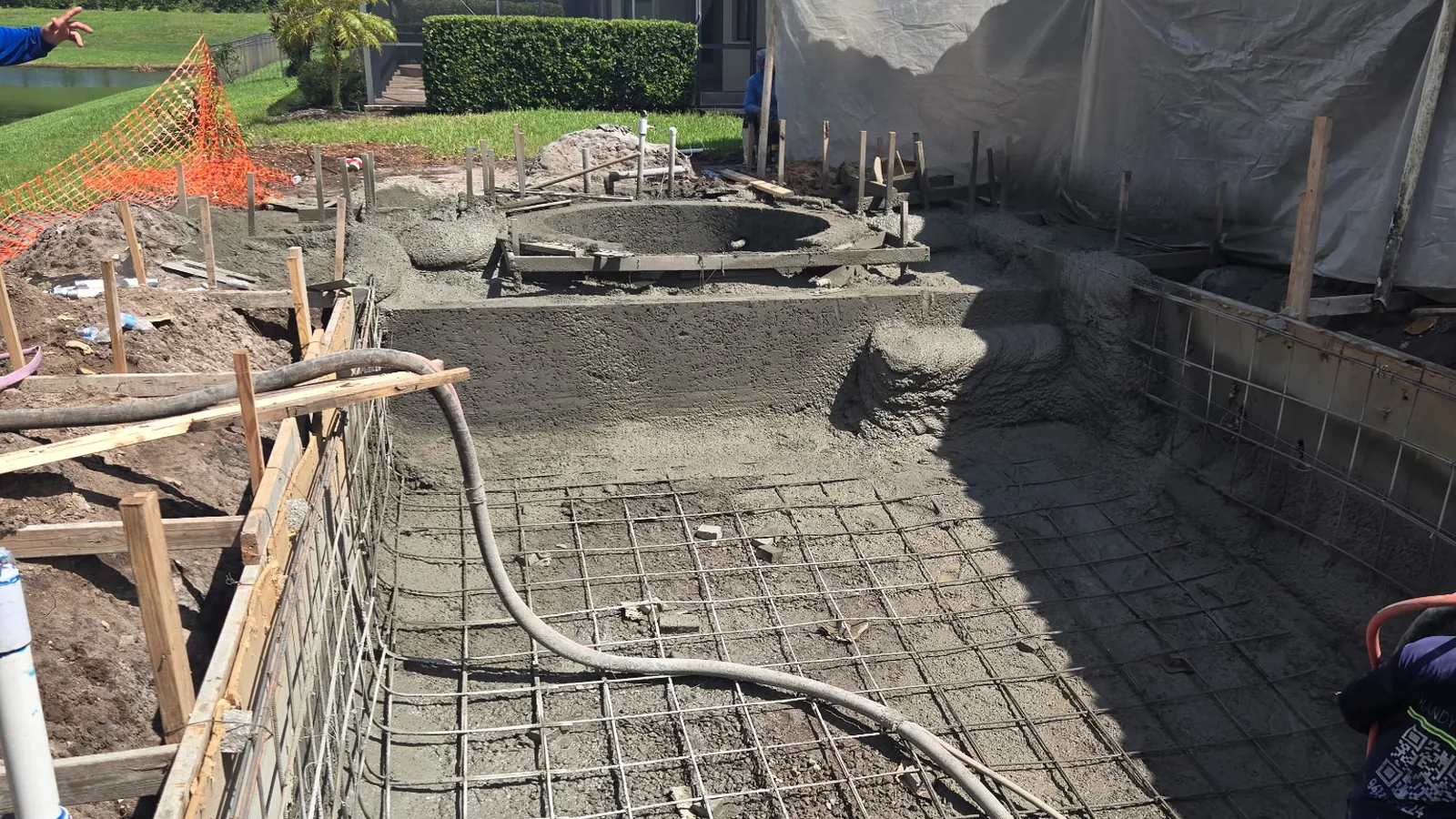 Freshly shot pool and spa shell curing on a lakefront lot