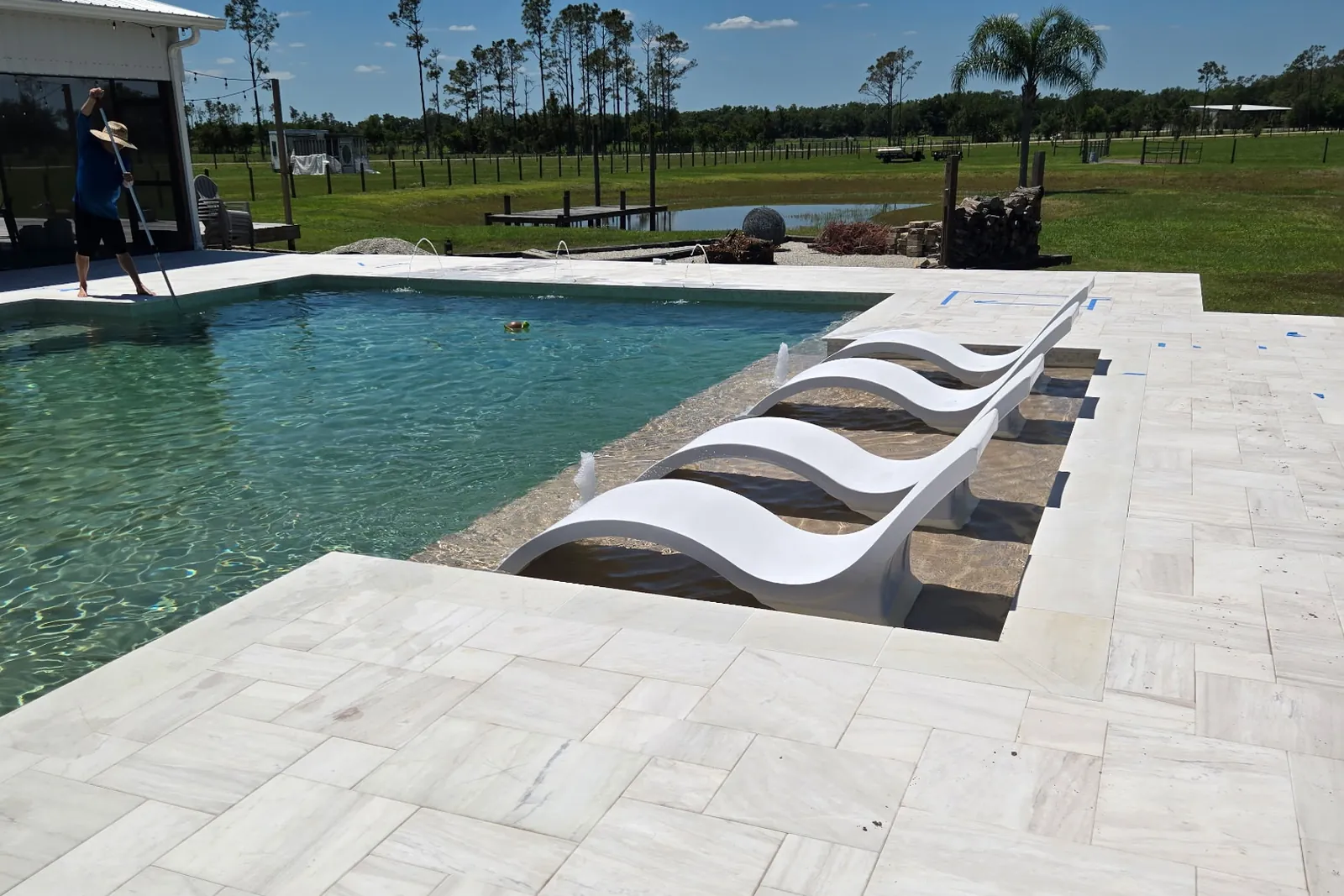 Finished geometric pool in Myakka with in-pool loungers on the sun shelf