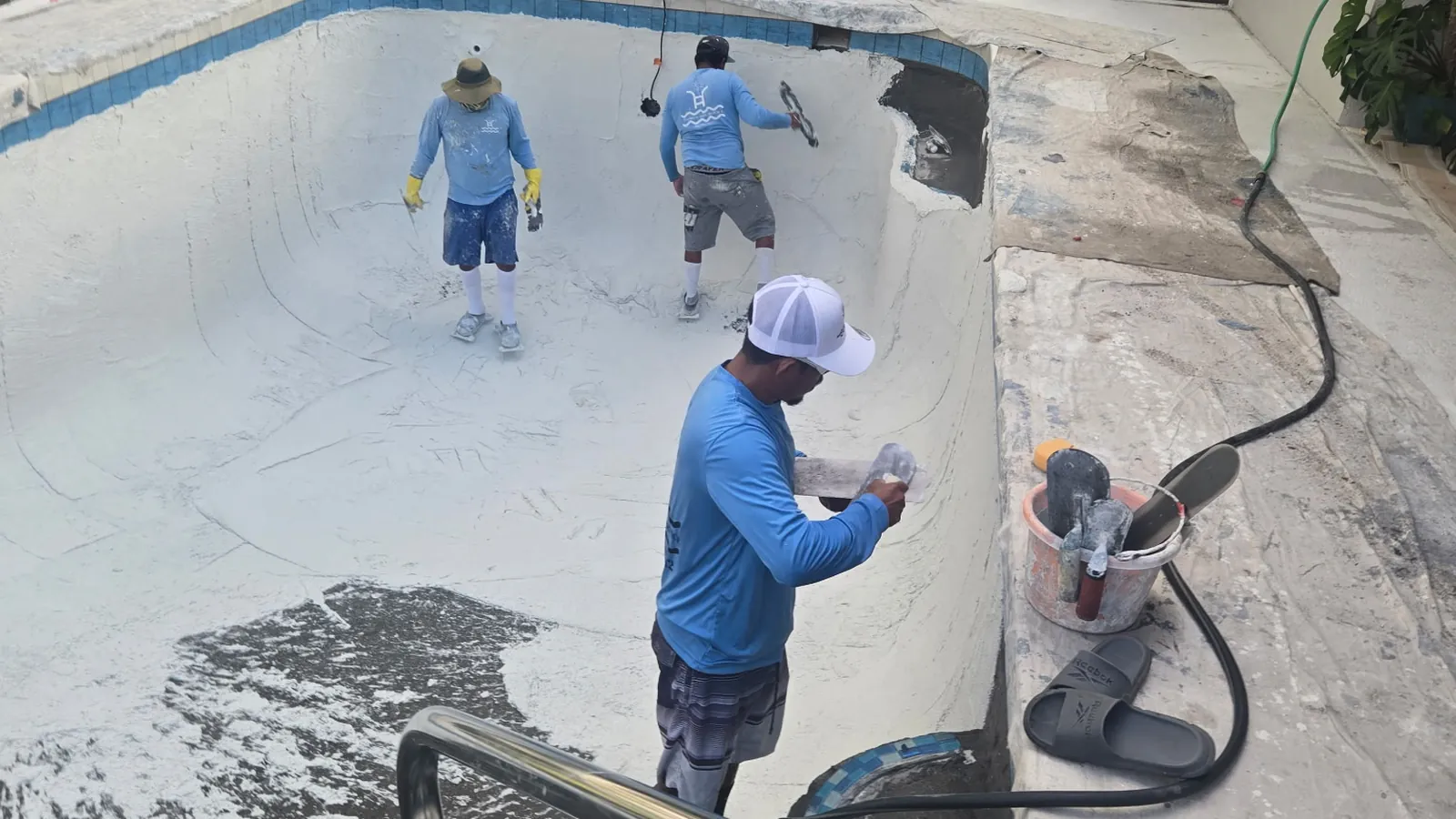 Crew applying a new interior finish to a pool during a remodel in Sarasota